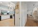 Hallway leading to the kitchen with tile floors and neutral paint at 4511 Swift Cir, Valrico, FL 33596