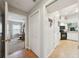 Hallway leading to the kitchen and bedroom with tile floors and neutral paint at 4511 Swift Cir, Valrico, FL 33596