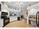 Bright kitchen with white cabinets, granite countertops, and stainless steel appliances with an open layout at 4511 Swift Cir, Valrico, FL 33596