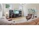 Well-lit living room with a comfortable sectional sofa, large windows, and a ceiling fan at 4511 Swift Cir, Valrico, FL 33596