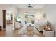 Cozy living room featuring neutral tones, a ceiling fan, and a sliding glass door to the outdoor patio at 4511 Swift Cir, Valrico, FL 33596