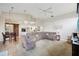 Open-concept living room with high ceilings, a sliding barn door, and a comfortable sectional sofa at 4511 Swift Cir, Valrico, FL 33596