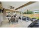 Covered outdoor patio with ceiling fans, string lights, and comfortable seating, great for entertaining at 4511 Swift Cir, Valrico, FL 33596