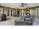 Inviting covered patio with comfortable seating, ceiling fans, and a large TV for outdoor entertainment at 4511 Swift Cir, Valrico, FL 33596