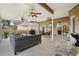 Covered patio with outdoor seating, ceiling fans, stone pavers, and outdoor television at 4511 Swift Cir, Valrico, FL 33596