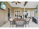 Covered patio with a dining table and comfortable seating, perfect for enjoying outdoor meals at 4511 Swift Cir, Valrico, FL 33596