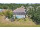 A bird's-eye view of a home with a screened-in pool, lush trees, and a well-kept lawn at 4535 29Th Avenue E Cir, Palmetto, FL 34221