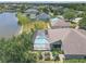 Aerial view of the property featuring a screened pool, garden, and lake views at 4535 29Th Avenue E Cir, Palmetto, FL 34221