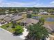 An aerial view shows the property's backyard, pond, and surrounding neighborhood at 4535 29Th Avenue E Cir, Palmetto, FL 34221