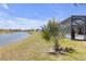 A pristine lawn with a view of the lake and screened lanai at 4535 29Th Avenue E Cir, Palmetto, FL 34221