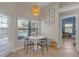 Cozy breakfast nook with a white table, modern chairs, and views of the pool at 4535 29Th Avenue E Cir, Palmetto, FL 34221