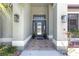 Inviting front entryway featuring a decorative door, sconces, and tiled patio at 4535 29Th Avenue E Cir, Palmetto, FL 34221