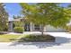 Landscaped front yard of single-story home featuring mature trees and manicured lawn at 4535 29Th Avenue E Cir, Palmetto, FL 34221