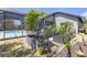 Charming garden with raised beds and mature plants beside a screened-in pool area at 4535 29Th Avenue E Cir, Palmetto, FL 34221