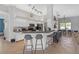 Open kitchen with white cabinets, a breakfast bar, and stainless steel appliances at 4535 29Th Avenue E Cir, Palmetto, FL 34221