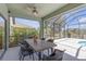 Screened in lanai featuring dining table and chairs overlooking a lake and lush backyard at 4535 29Th Avenue E Cir, Palmetto, FL 34221