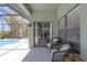 Covered outdoor patio offers comfortable seating with access to the screened pool area at 4535 29Th Avenue E Cir, Palmetto, FL 34221