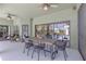Covered patio with dining set, overlooking the pool and a peek of the well maintained backyard at 4535 29Th Avenue E Cir, Palmetto, FL 34221