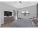 Bright main bedroom with a pool view, TV, dresser, and large windows at 4535 29Th Avenue E Cir, Palmetto, FL 34221