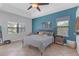Serene main bedroom with a teal accent wall, two windows, and neutral furnishings at 4535 29Th Avenue E Cir, Palmetto, FL 34221