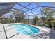 Sparkling pool area with a screen enclosure, surrounded by lush landscaping and a serene lake view at 4535 29Th Avenue E Cir, Palmetto, FL 34221