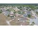 Wide aerial shot showing home's location in a verdant neighborhood with mature trees and nearby houses at 4617 Horseshoe Pick Ln, Valrico, FL 33594