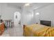 Bedroom area featuring tiled floors, neutral walls, and an arched entry at 4617 Horseshoe Pick Ln, Valrico, FL 33594
