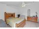 Comfortable bedroom with a ceiling fan, dresser, and a cozy armchair at 4617 Horseshoe Pick Ln, Valrico, FL 33594
