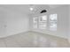 Bright bedroom with a fan, three windows, and tiled flooring at 4617 Horseshoe Pick Ln, Valrico, FL 33594