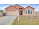Charming single-story home with a manicured lawn, a two-car garage, and an inviting front entrance at 4617 Horseshoe Pick Ln, Valrico, FL 33594