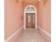 Inviting covered entryway featuring an ornate wooden door with glass details and a decorative hanging light fixture at 4617 Horseshoe Pick Ln, Valrico, FL 33594