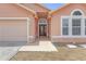 The front entrance showcases an elegant wooden door with decorative glass and tiled walkway at 4617 Horseshoe Pick Ln, Valrico, FL 33594