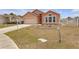 Well-maintained front yard with dry grass and landscaping that enhances the curb appeal of the property at 4617 Horseshoe Pick Ln, Valrico, FL 33594