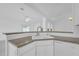 Kitchen bar with granite countertops and view to the living room at 4617 Horseshoe Pick Ln, Valrico, FL 33594