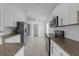 Modern kitchen featuring white cabinets, stainless steel appliances, and granite countertops at 4617 Horseshoe Pick Ln, Valrico, FL 33594