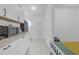 Kitchenette with subway tile backsplash, stainless steel appliances, and tiled flooring at 4617 Horseshoe Pick Ln, Valrico, FL 33594
