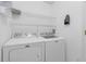 Laundry room with a modern washer and dryer, and overhead storage shelves at 4617 Horseshoe Pick Ln, Valrico, FL 33594
