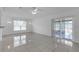Living area features tile floors, decorative tile area, and sliding glass door at 4617 Horseshoe Pick Ln, Valrico, FL 33594