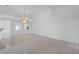 Bright living room featuring tile floors, a chandelier, and high ceilings at 4617 Horseshoe Pick Ln, Valrico, FL 33594