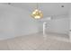 Open living space with tile floors, neutral walls, and an elegant chandelier at 4617 Horseshoe Pick Ln, Valrico, FL 33594