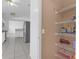 Open pantry with shelving next to a kitchen featuring stainless steel refrigerator at 4617 Horseshoe Pick Ln, Valrico, FL 33594
