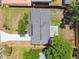 Aerial view showcasing the home's roof, driveway, and the fenced backyard, highlighting the property layout at 4940 Rosedale Ln, Holiday, FL 34690