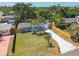 Aerial view of the home with fenced yard, long driveway, and lush greenery in the neighborhood at 4940 Rosedale Ln, Holiday, FL 34690