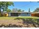 This fenced backyard features a screened porch attached to the home, with room for a garden at 4940 Rosedale Ln, Holiday, FL 34690