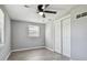 Bedroom featuring new floors, ceiling fan, and double door closet at 4940 Rosedale Ln, Holiday, FL 34690
