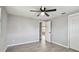 Bedroom featuring new floors, ceiling fan, and door at 4940 Rosedale Ln, Holiday, FL 34690