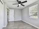 Bedroom featuring new floors, ceiling fan, and view of outside at 4940 Rosedale Ln, Holiday, FL 34690