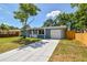 Charming single-story home with a well-manicured lawn, long driveway, and an attached one car garage at 4940 Rosedale Ln, Holiday, FL 34690