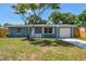 Charming single-story home with a well-maintained front yard and attached garage at 4940 Rosedale Ln, Holiday, FL 34690