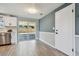Eat-in kitchen with stainless steel dishwasher, white shaker cabinets, new floors, and slider door access to backyard at 4940 Rosedale Ln, Holiday, FL 34690